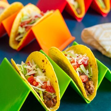 Taco holders holding assembled Ground Beef Tacos.