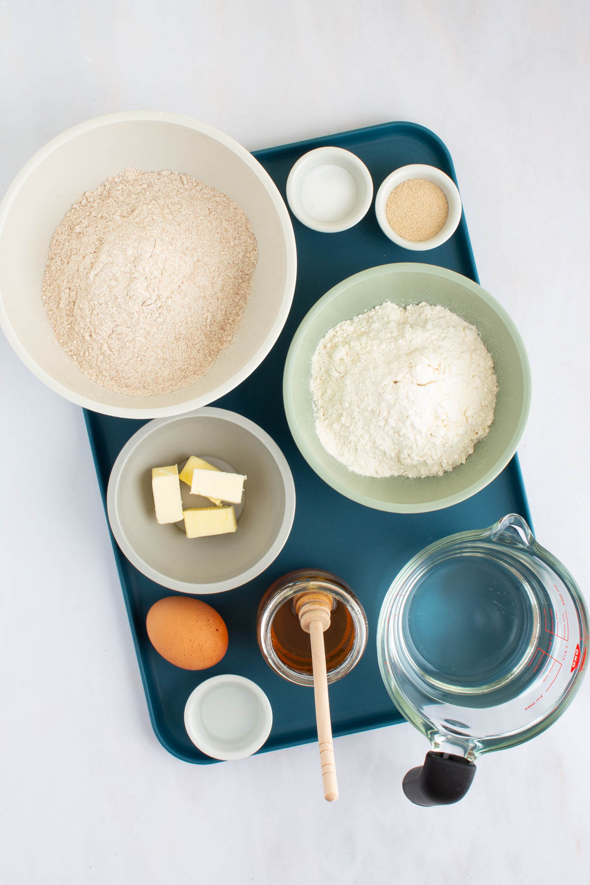 Ingredients for Easy Honey Wheat Sandwich Bread on a tray.