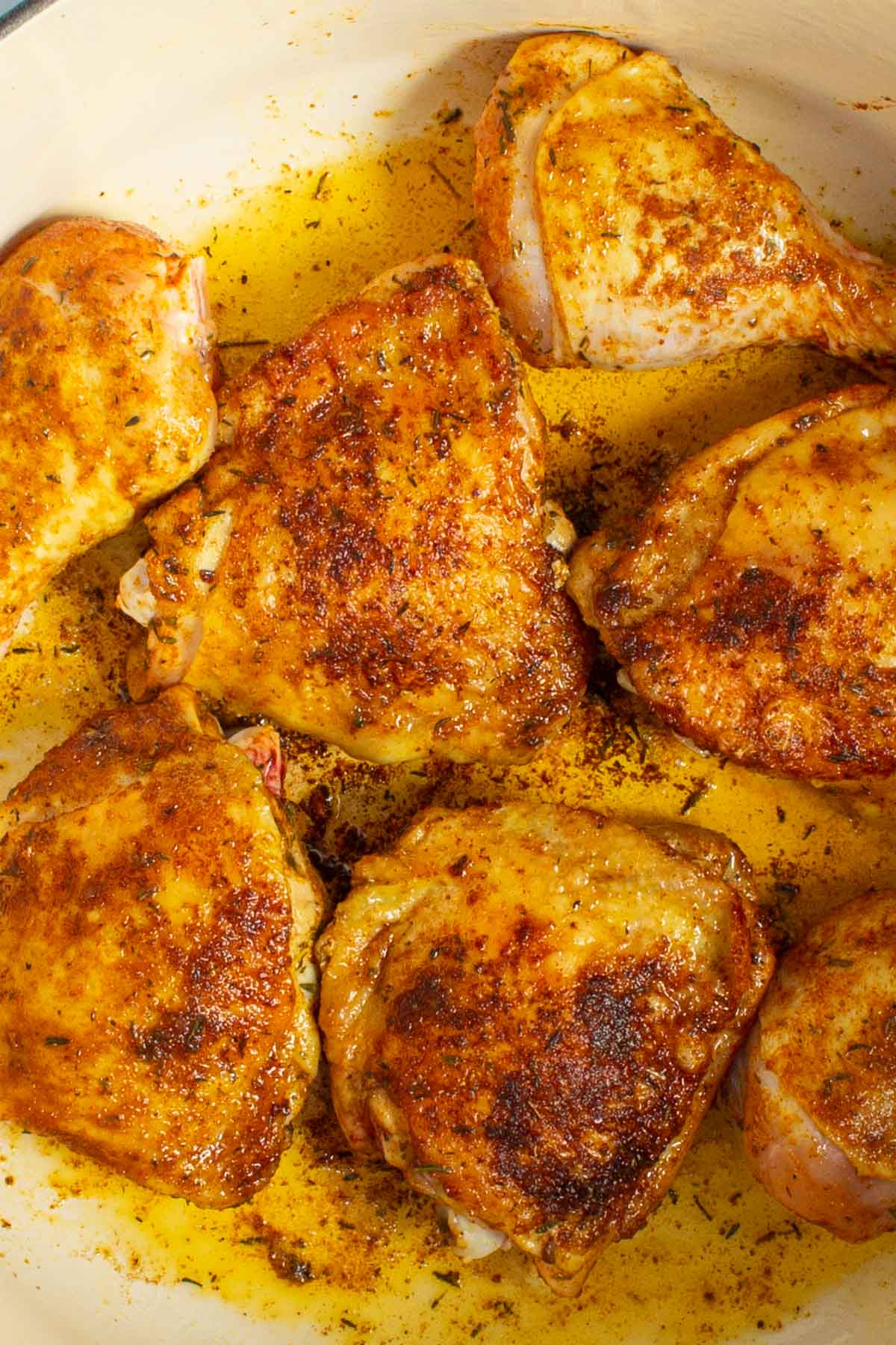 Browned chicken pieces in a pot for Nigerian Red Stew.