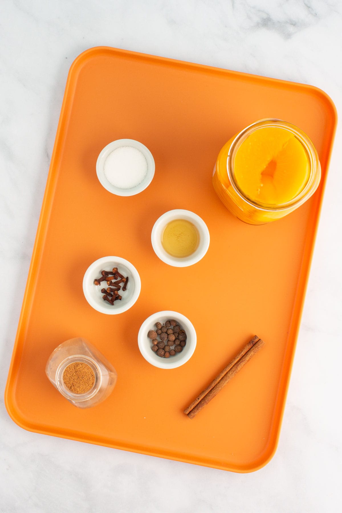 Ingredients for spiced peach nectar measured out on a tray.