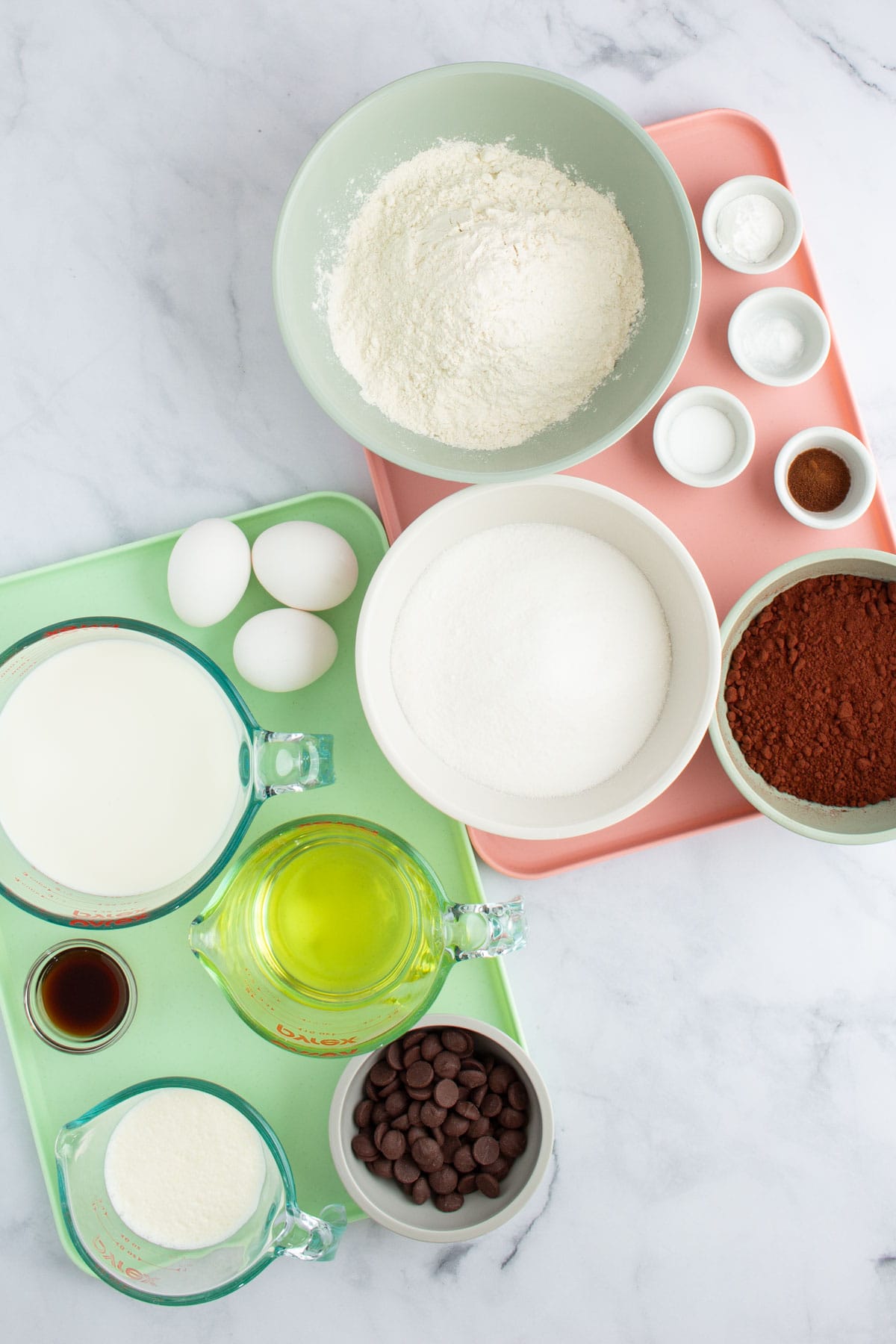 Ingredients for Chocolate Ganache Cake measured out into bowls on two trays.