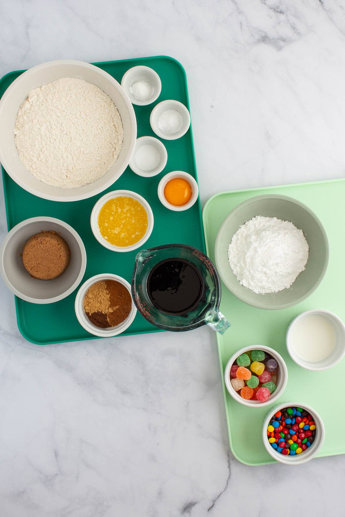 Ingredients for easy gingerbread cookies measured out on two trays.