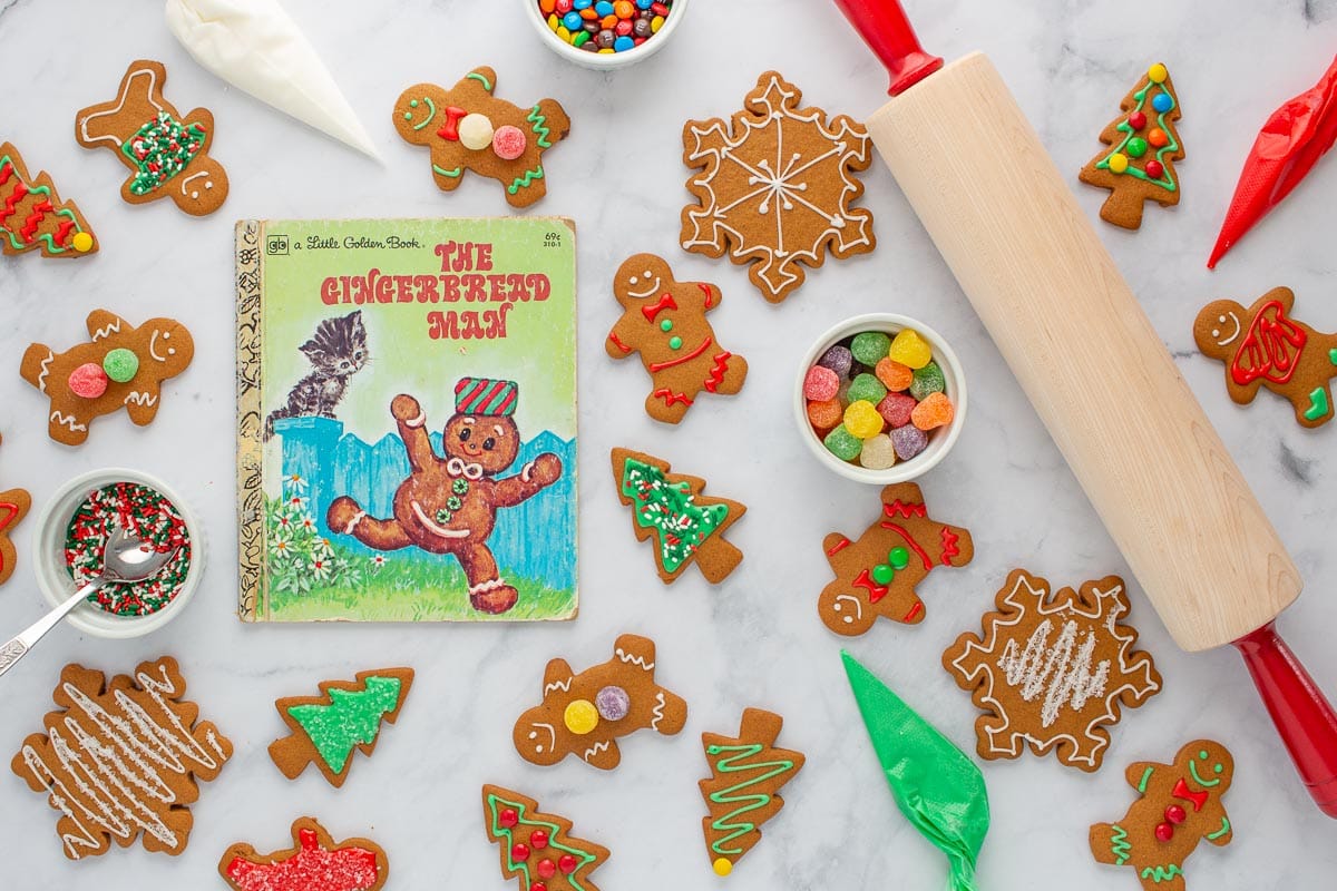 The cover of the book The Gingerbread Man, surrounded by baked gingerbread cookies and decorating supplies.