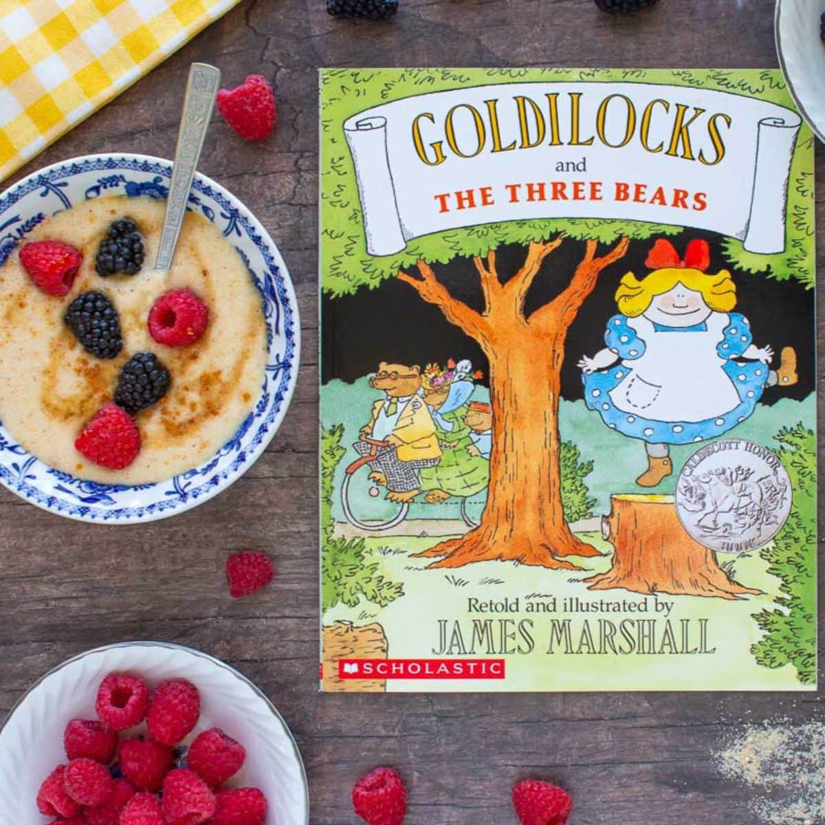 The cover of the book Goldilocks and the Three Bears next to a bowl of maple cream of wheat with berries.