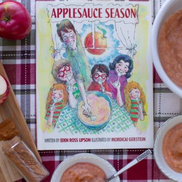 The cover of the book Applesauce Season surrounded by bowls of homemade appleauce.