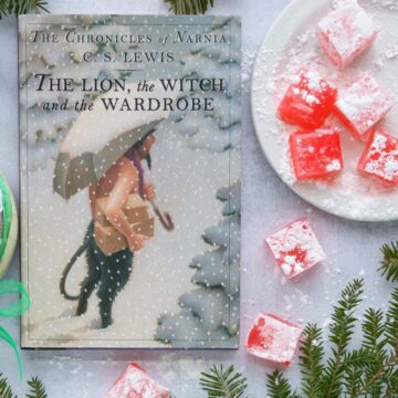 The cover of the book The Lion, the Witch, and the Wardrobe next to a serving plate of Turkish Delight.