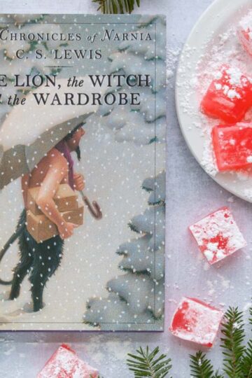 The cover of the book The Lion, the Witch, and the Wardrobe next to a serving plate of Turkish Delight.