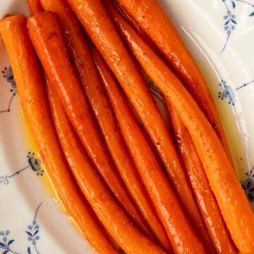 Honey roasted carrots in a serving platter with sauce.