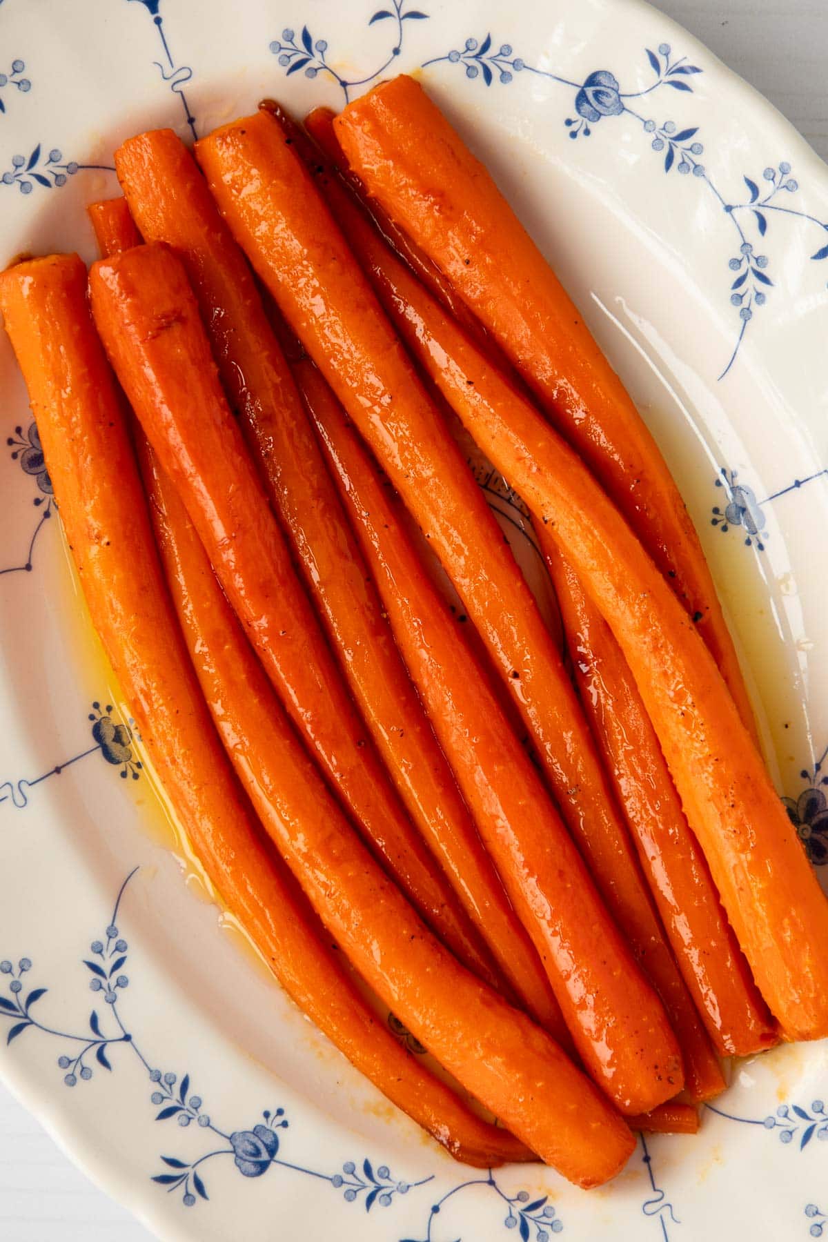 Honey roasted carrots in a serving platter with sauce.