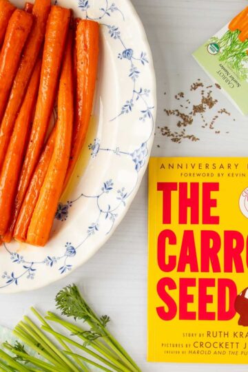 The cover of the book The Carrot Seed next to a platter of honey roasted carrots and a packet of carrot seeds.