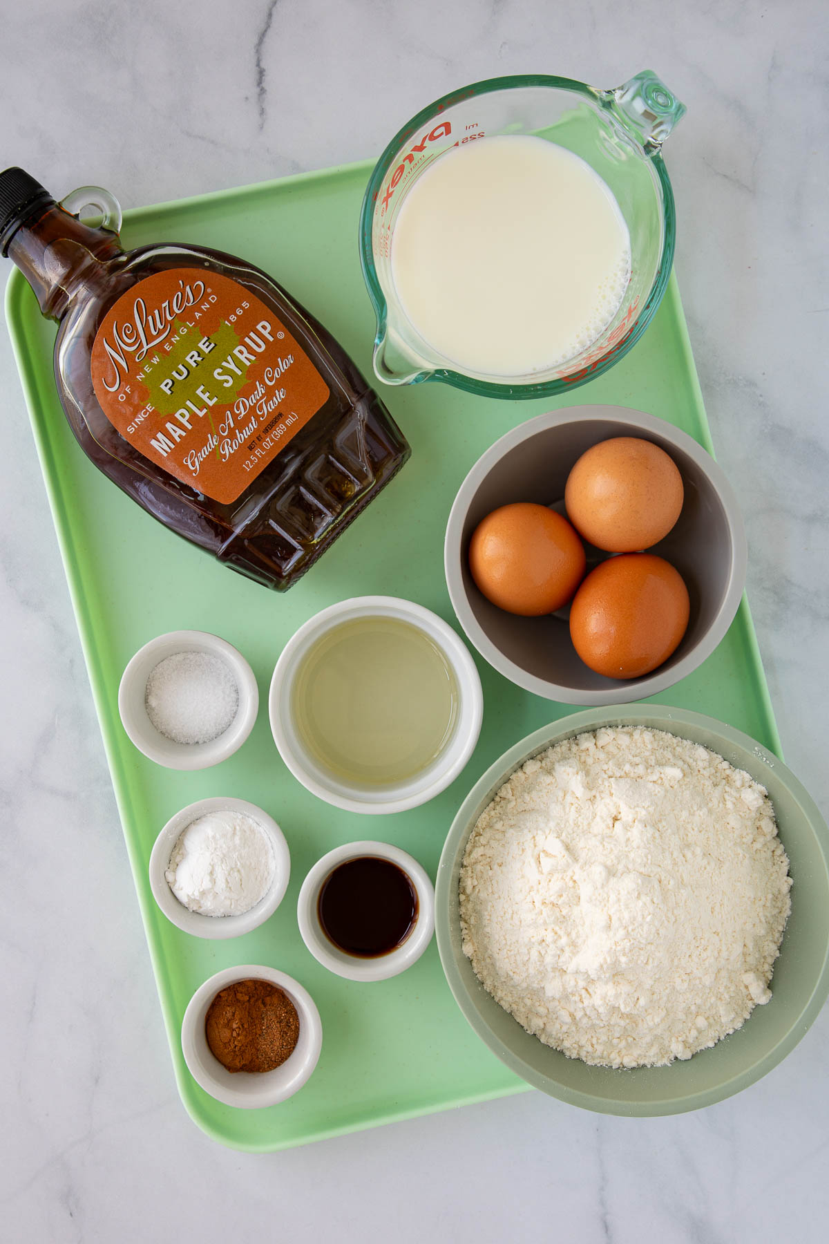 Ingredients for One-Bowl French Toast Pancakes measured out on a tray.