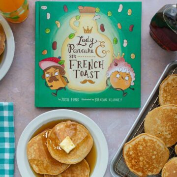 Two plates and a tray of pancakes with syrup next to the cover of the book Lady Pancake & Sir French Toast.