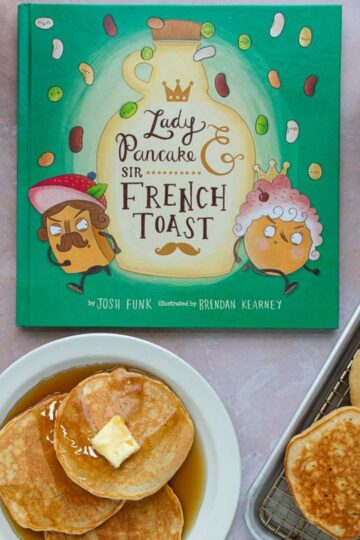 Two plates and a tray of pancakes with syrup next to the cover of the book Lady Pancake & Sir French Toast.